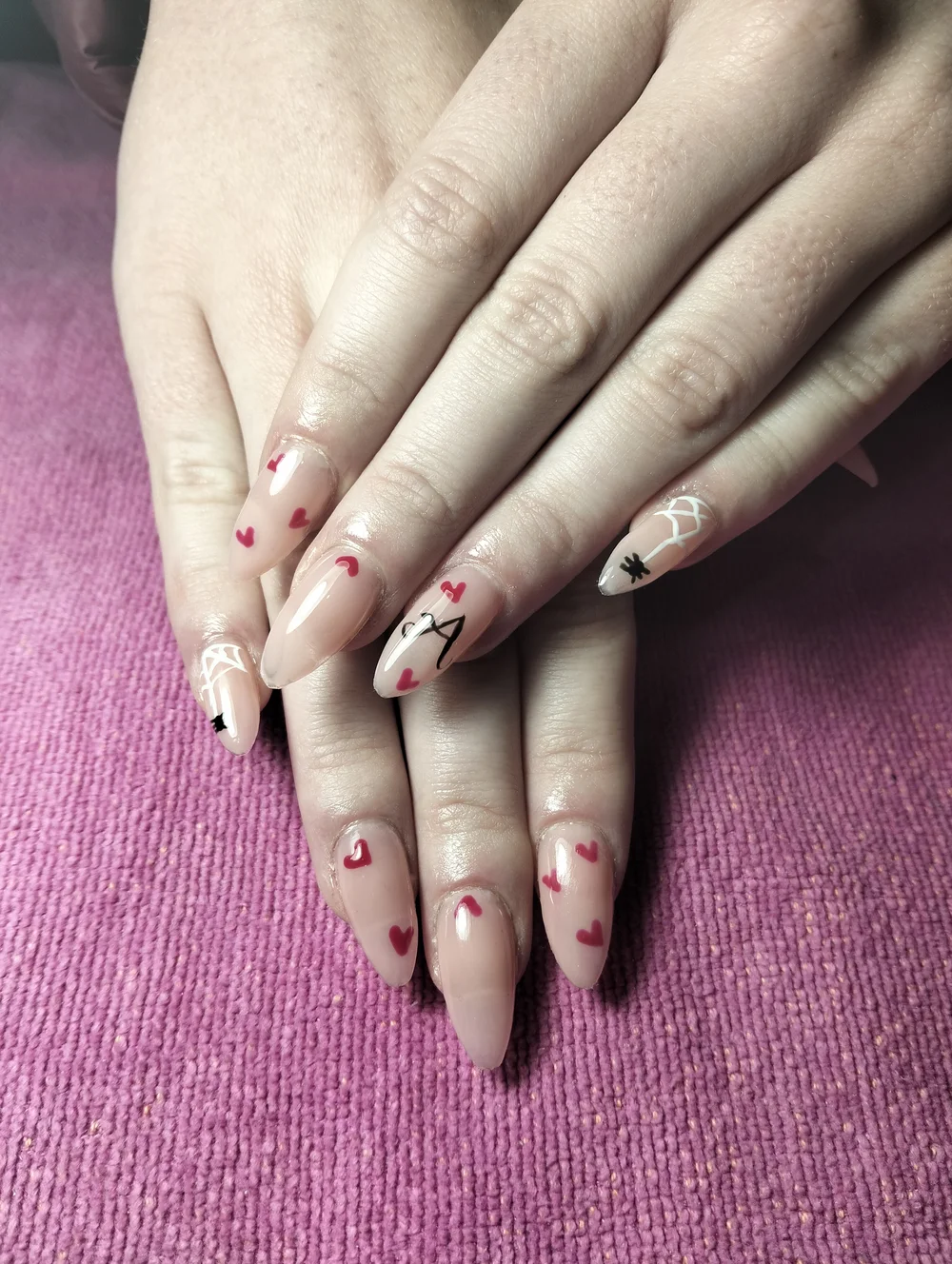 Soft pink almond nails with delicate red nail art